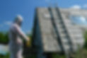 Asbestos removal worker removing asbestos from a roof