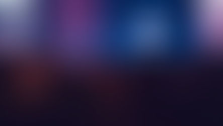 Blurred speaker on stage before a seated audience, bathed in blue and purple light at a live event