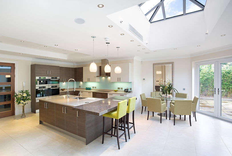 Modern kitchen with a central island, sleek cabinets, pendant lights, and dining area