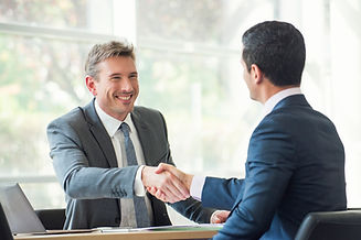 Businessmen shaking hands in meeting