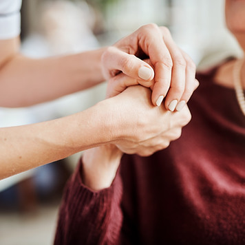 Cropped shot of a nurse holding an elderly woman's hands in a retirement home