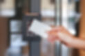 Door access control - young woman holding a key card to lock and unlock door