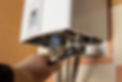 Cropped view of a plumber fixing a boiler pipe