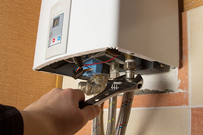 plumber repairing a gas water heater