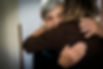 An old woman hugging a carer