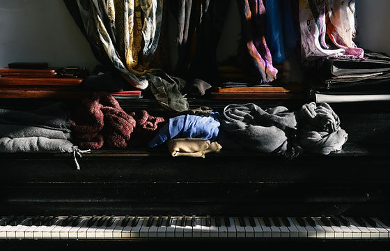 Piles of Clothes on a Piano