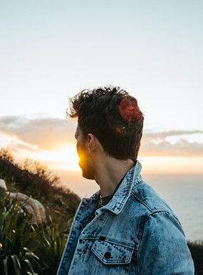 man in addiction recovery stares at sunset