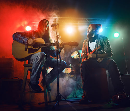 Akustik-Duo performt auf Bühne mit Gitarre und Ukulele beim Teambuilding Event Workshop. Live-Musik für Ihr Teamevent in München