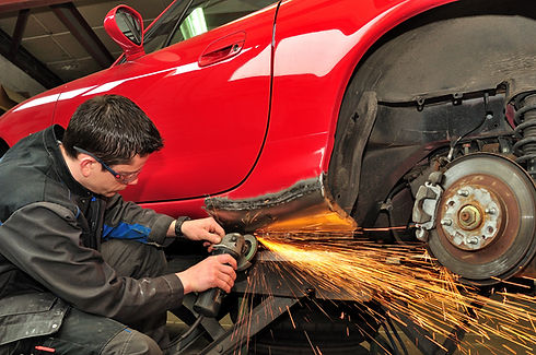 Worker repairing car body