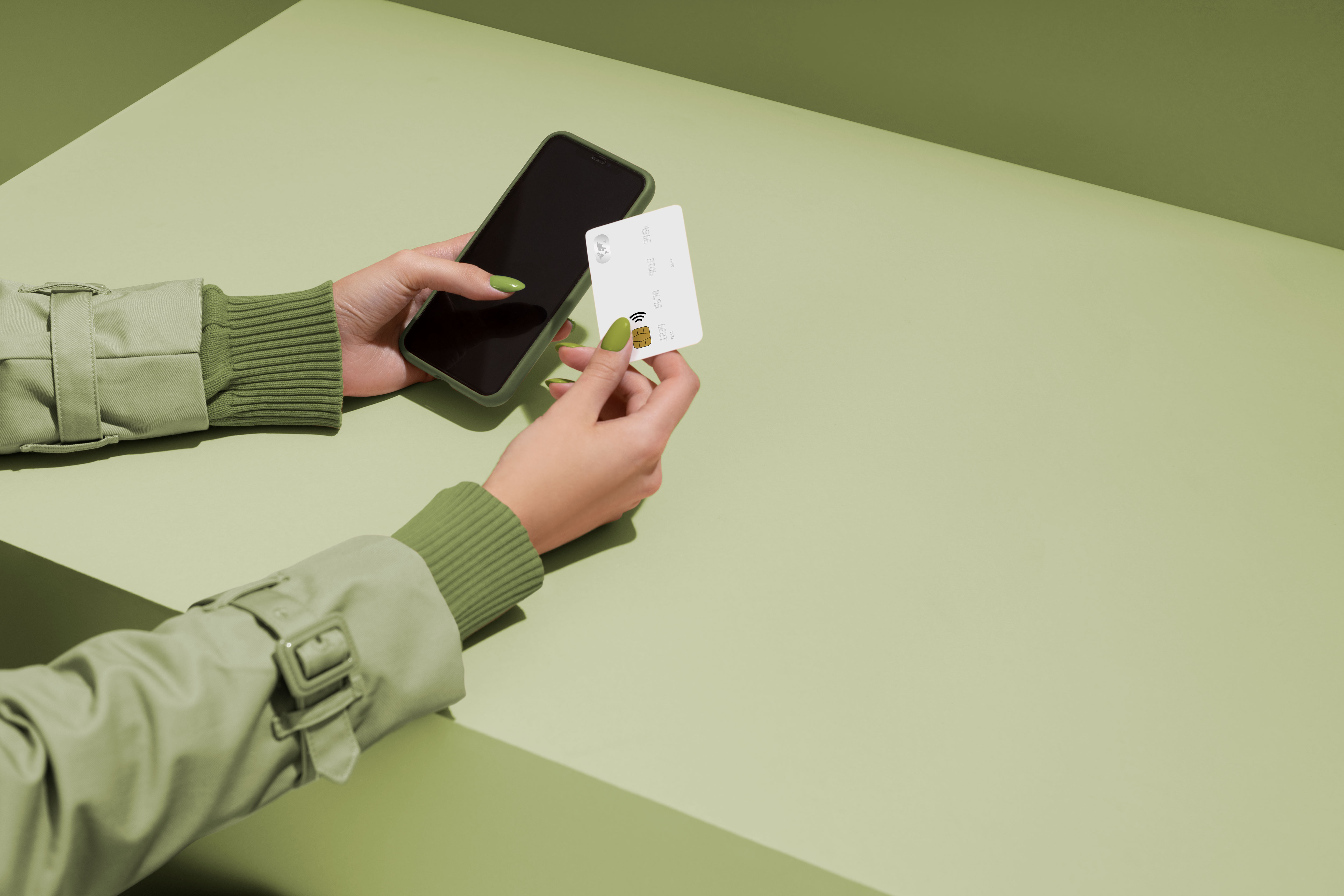 Person holding a smartphone and a credit card, representing online transactions at Techmave Mauritius, a tech store.