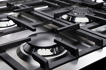A Natural Gas Stove With Lit Burners