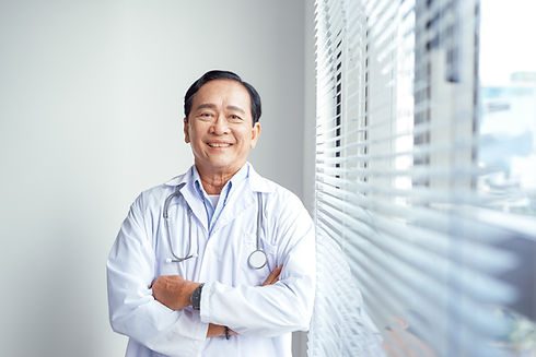 Portrait of Asian doctor standing in white coat