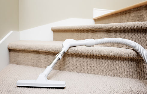 Vacuum cleaner lying down dangerously in stairway covered by carpet