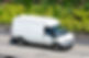 A white van speeds along a road