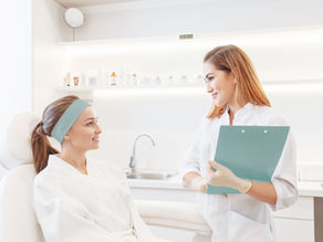 aesthetic practitioner consulting with patient in clinic