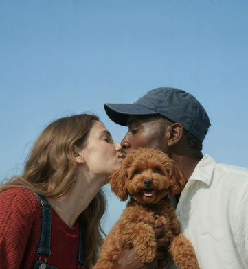 couple kissing with their dog. Pet Life with their dog.