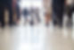 Business people rushing through office hall, reflections on tiled floor