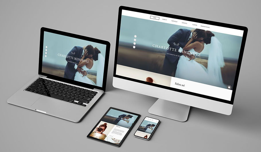 An image showcases a laptop, desktop monitor, tablet, and smartphone, all displaying the same scene of a couple outdoors. This highlights the seamless experience offered by professional web design services for businesses aiming for consistency across devices.