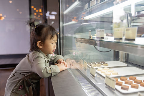 Little Girl Looking at Pastries