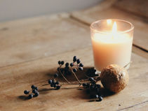 soft candle lit sitting on a wood table