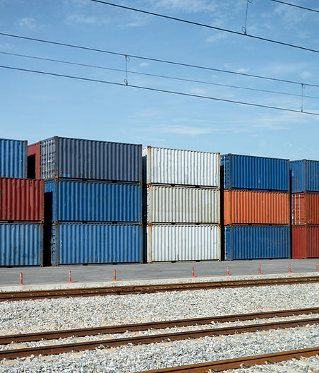 Stack of Containers by a railway