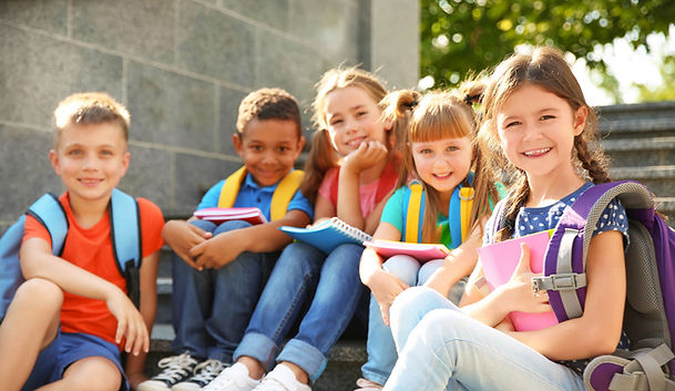 Children smiling with supplies