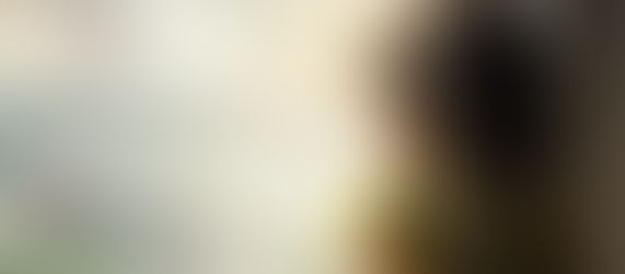 A child looking out the window on a rainy day