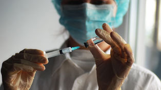 woman administering vaccine