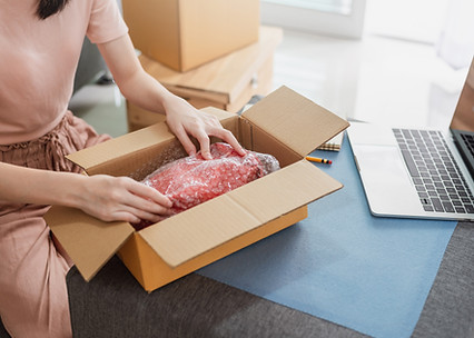 Woman packing her order for delivery