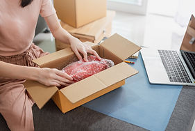Woman packing her order for delivery