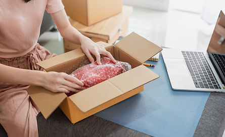 Woman packing her order for delivery