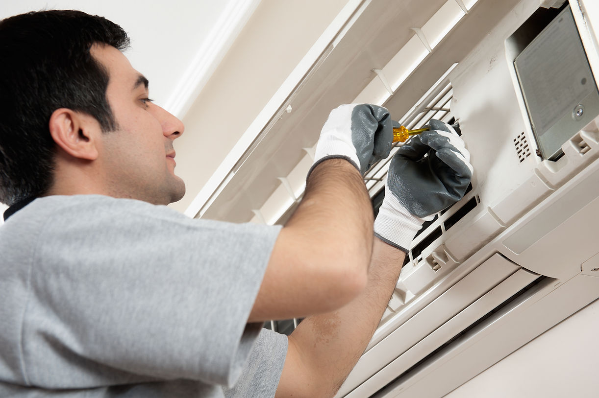 Air conditioner technician servicing indoor