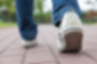Teenager walking in sport shoes, summer day