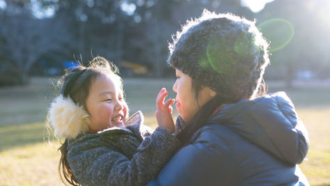child with her mother playing
