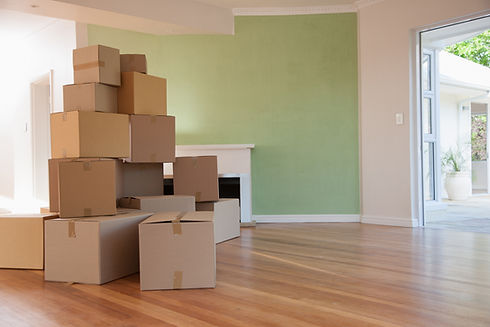 Boxes stacked in living room of new house
