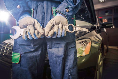 Car Mechanic Ready For Work. Auto Mechanic with Large Wrench in Hands