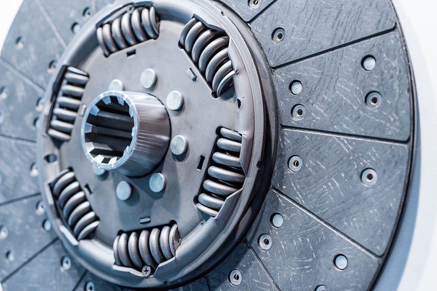 Close-up of a metallic vehicle clutch disc with visible springs and bolts