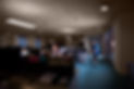 a young woman has stayed behind to get her work done in a large open plan office . A clean