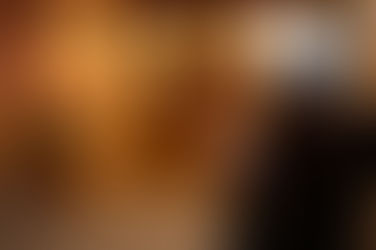 Person standing quietly outdoors in winter holding a warm drink, reflecting during the holiday season