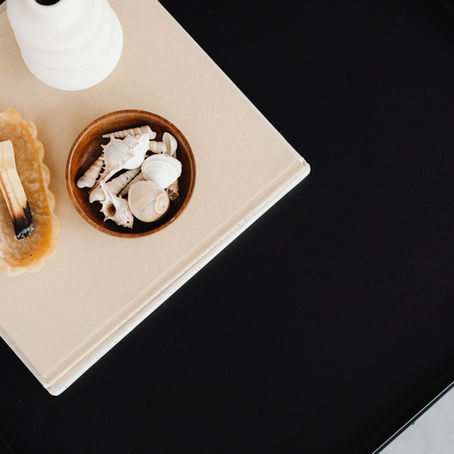 table with shells in a bowl and sandalwood burning