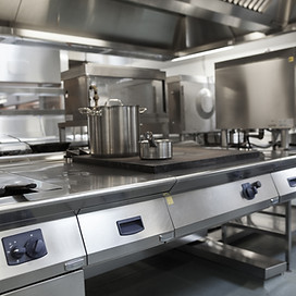 Picture of fully equipped professional kitchen in bright light