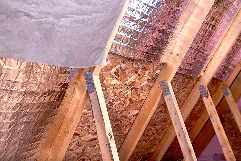 Inside gable and joist view of ongoing project, insulation of attic with fiberglass cold b