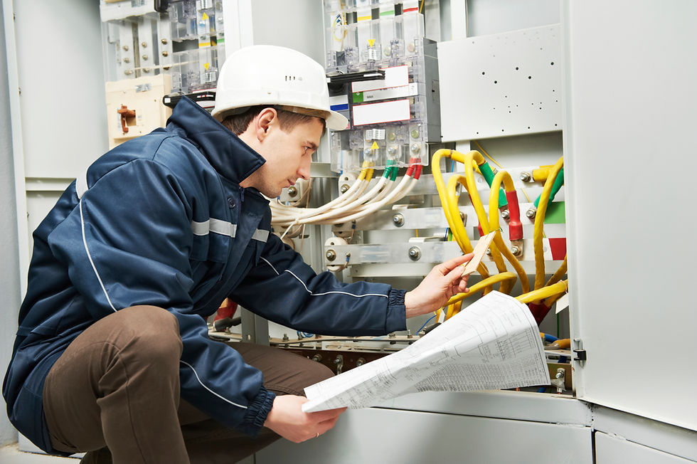 Engineer testing wiring on a control panel