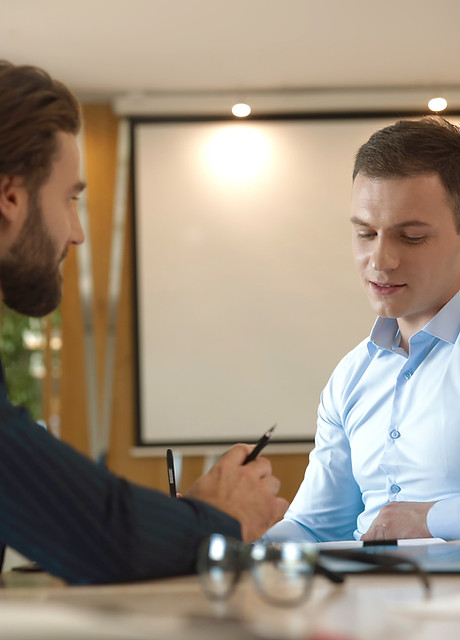 Two men in business setting collaborating