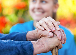 Young female doctor holding his patient hand