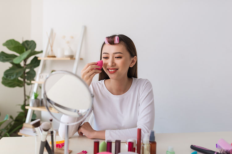 Asian woman applying blush
