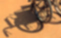 wheelchair and shadow on a cement background at an outdoor
