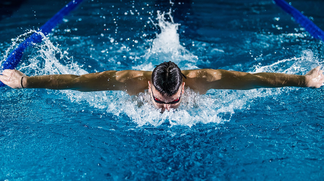 Fairhope Heat swimmer receiving professional coaching during structured training session, showcasing the program's commitment to excellence