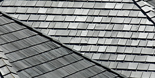 Close up shot of grey tiled roof installation during property renovation