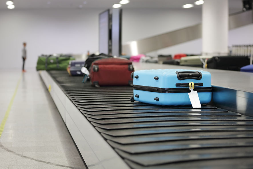Suitcase or luggage on conveyor belt in the airport waiting